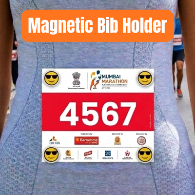A person wearing a blue patterned athletic bib shirt with a printed race bib pinned to the front. An orange banner at the top reads 'Magnetic Bib Holder.